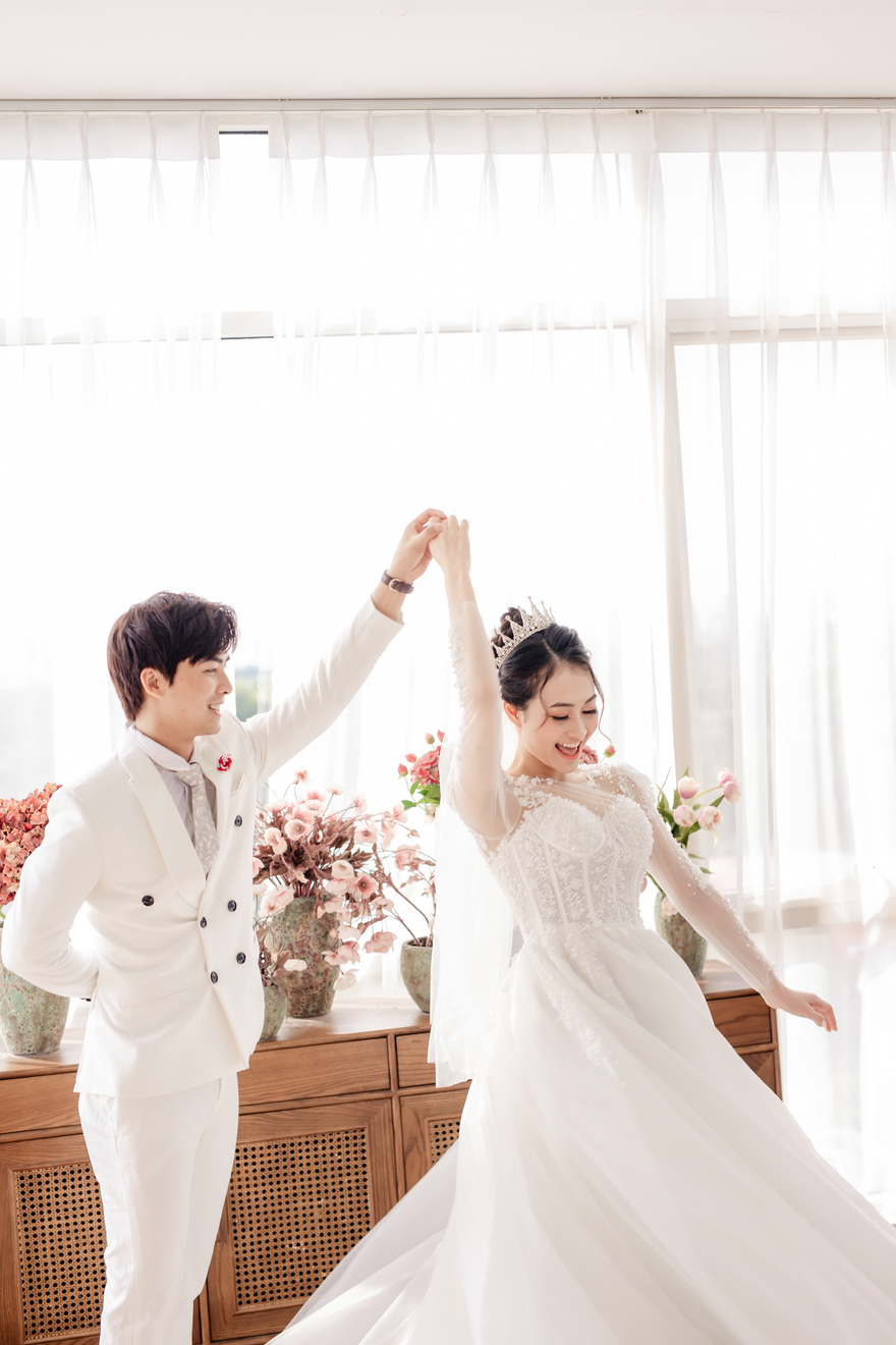 Happy ethnic newlywed couple dancing at wedding ceremony